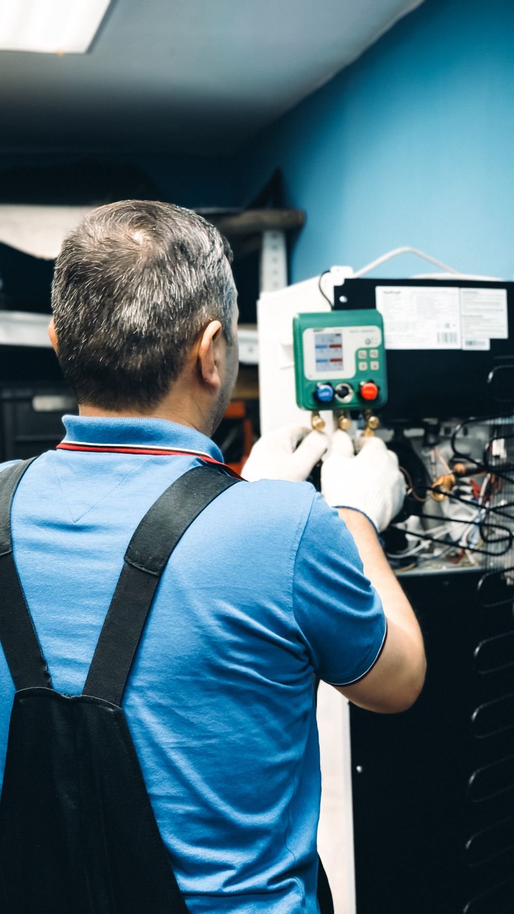 Technician servicing an air conditioning unit